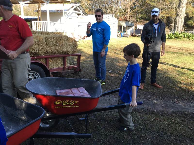 Kids with a wheelbarrow on a relief work day.