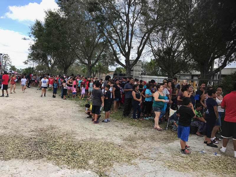 A long line of people at an outdoor service event.