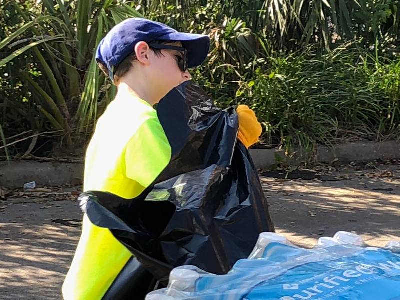 A child bagging donated items.