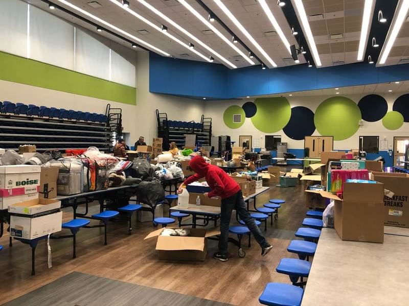 Volunteers packing boxes in a supply room.