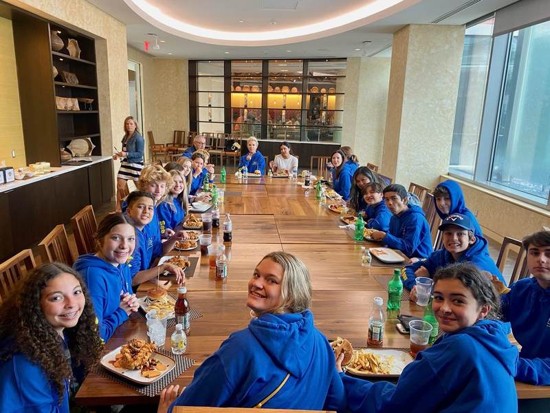 See Us Now members at a long lunch table.