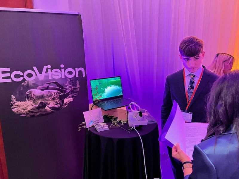 An Ecovision booth with the logo and a headset on display.