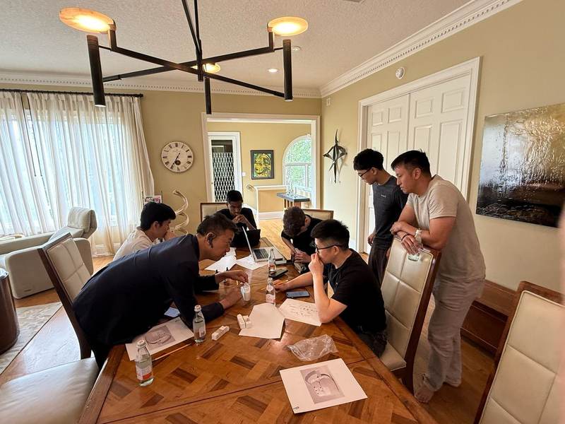 Students gathered around a table during an EBIT work session.